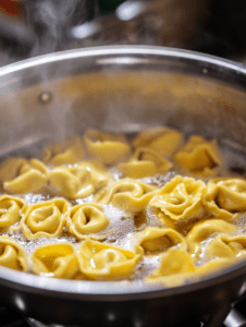 Boil a large pot of salted water and cook tortellini according to package instructions. Drain and rinse with cold water