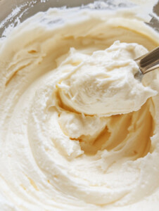 In a mixing bowl, combine Greek yogurt, ricotta cheese, sugar substitute, and vanilla extract. Whisk until smooth and creamy.