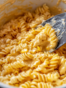 Stir in ranch seasoning, paprika, salt, pepper, and heavy cream. Simmer for 3–4 minutes, then add corn and 1 cup of cheddar cheese. Stir until smooth.